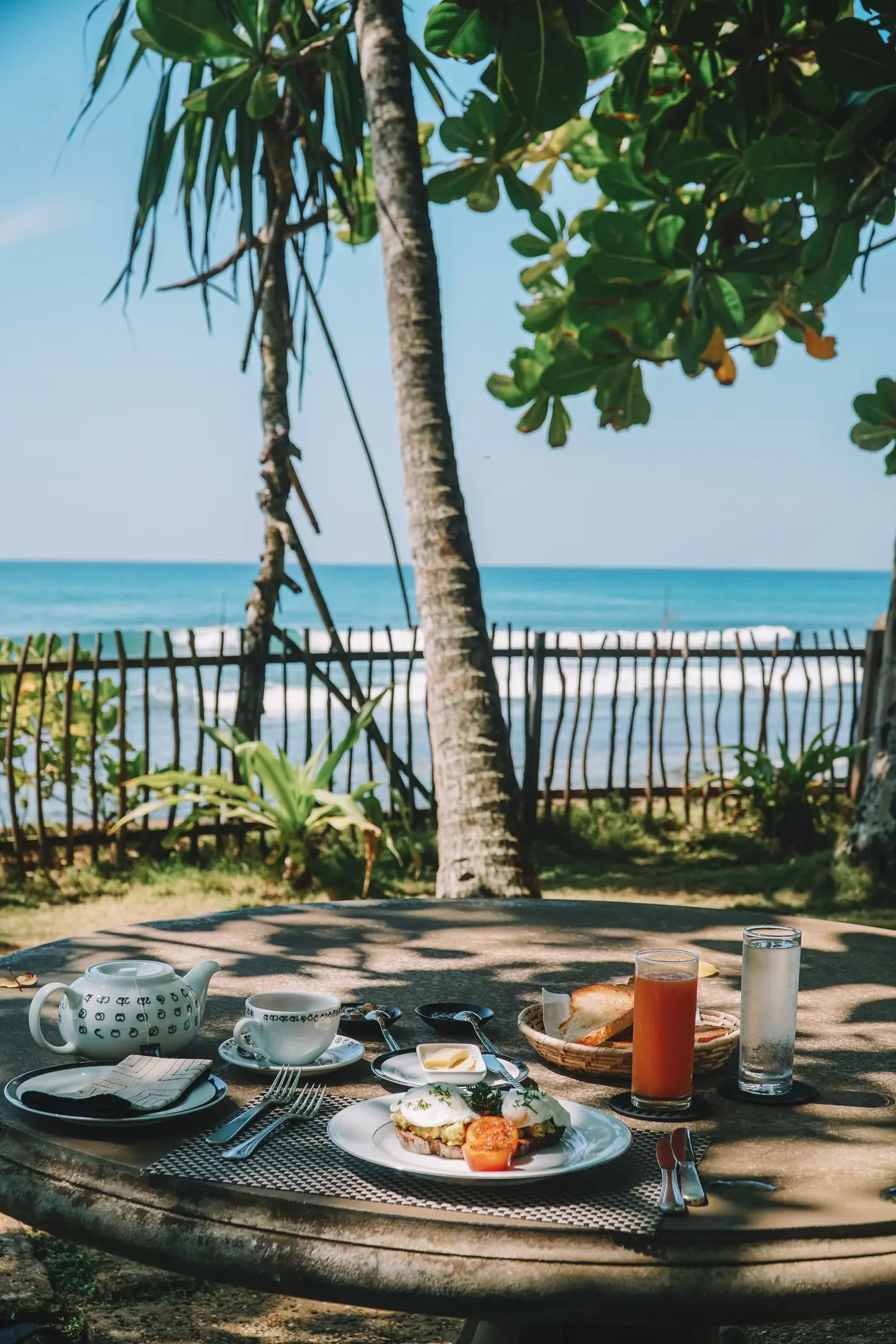 A traditional Sri Lankan breakfast table set beside the ocean