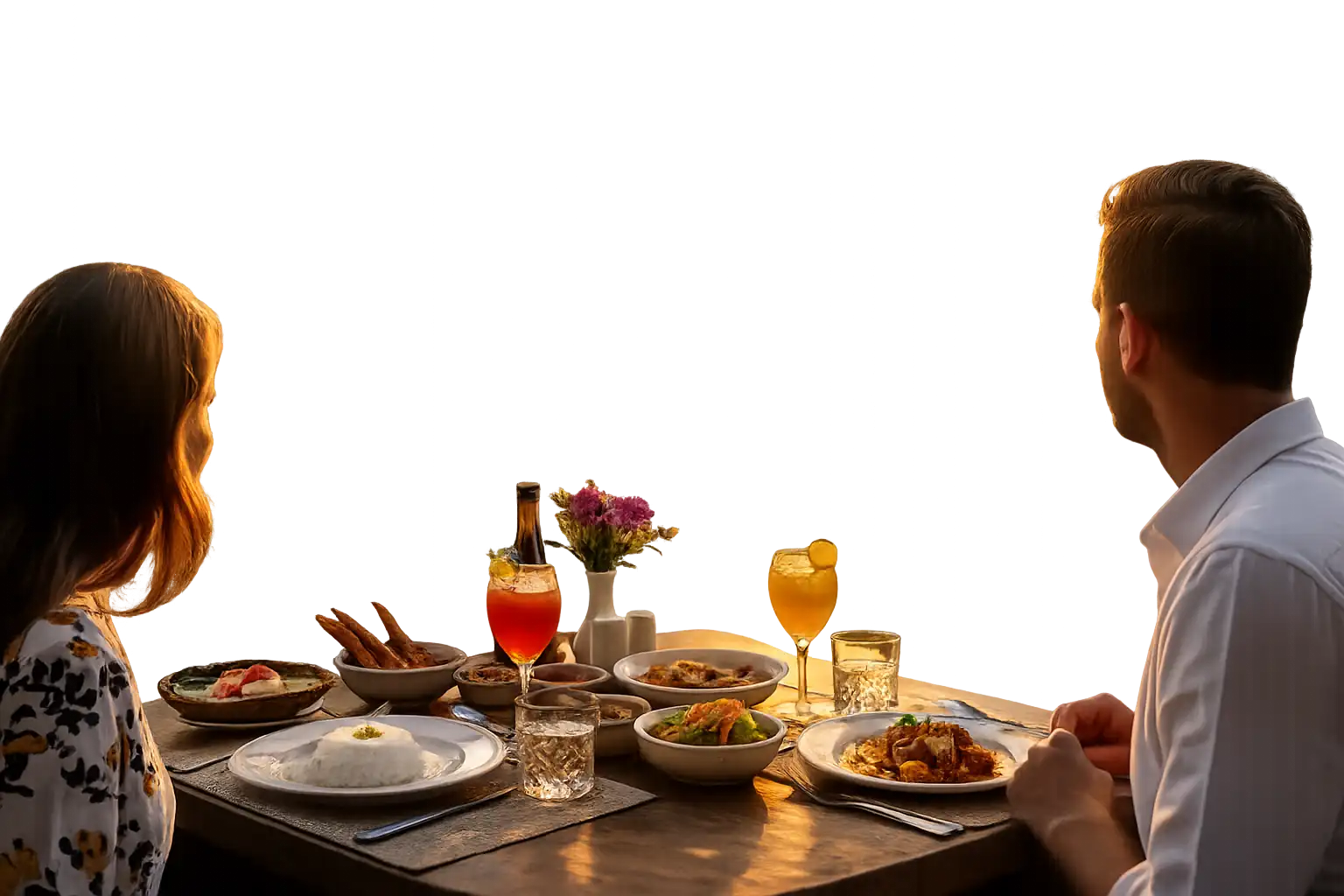 Couple dining at a beachfront table watching a Sri Lankan sunset